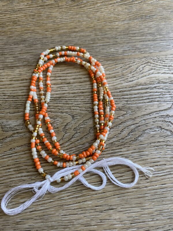 Orange, white, and gold beaded necklace.