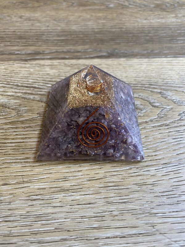 Amethyst crystal pyramid with gold flakes.