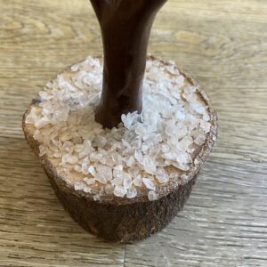 Close up of a wooden tree base with clear crystals.