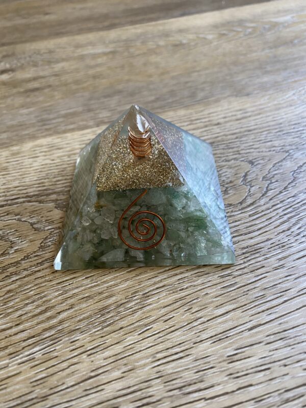 Green and gold crystal pyramid with wire.