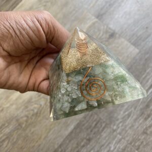 Green crystal pyramid with copper wire.