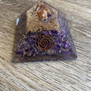 Amethyst crystal pyramid with gold flakes.