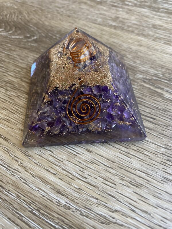 Amethyst crystal pyramid with gold flakes.