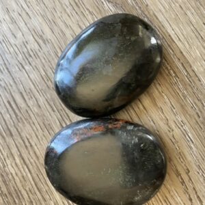 Two smooth black and red stones.