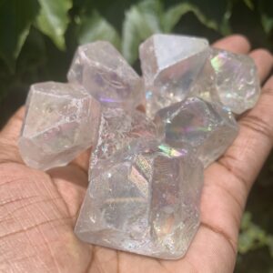 Clear iridescent crystals in hand.