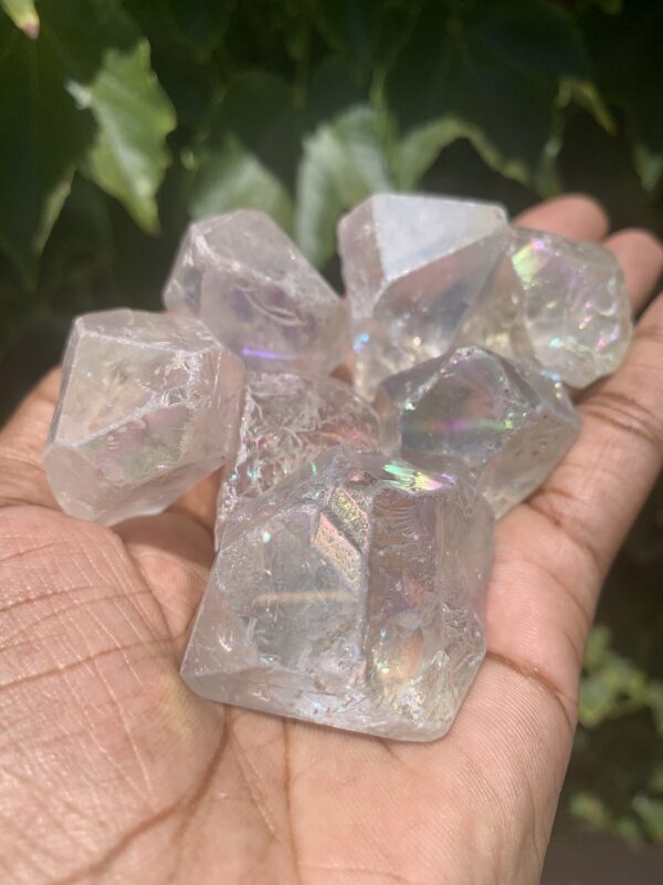 Clear iridescent crystals in hand.