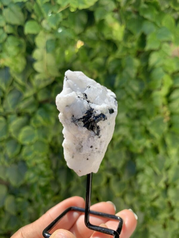 White moonstone crystal on a stand.