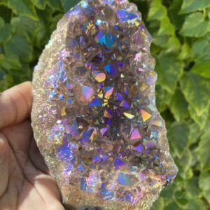 Hand holding a large iridescent crystal.