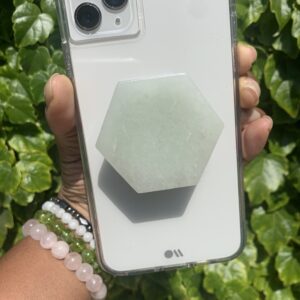 A white phone case with a green stone grip.