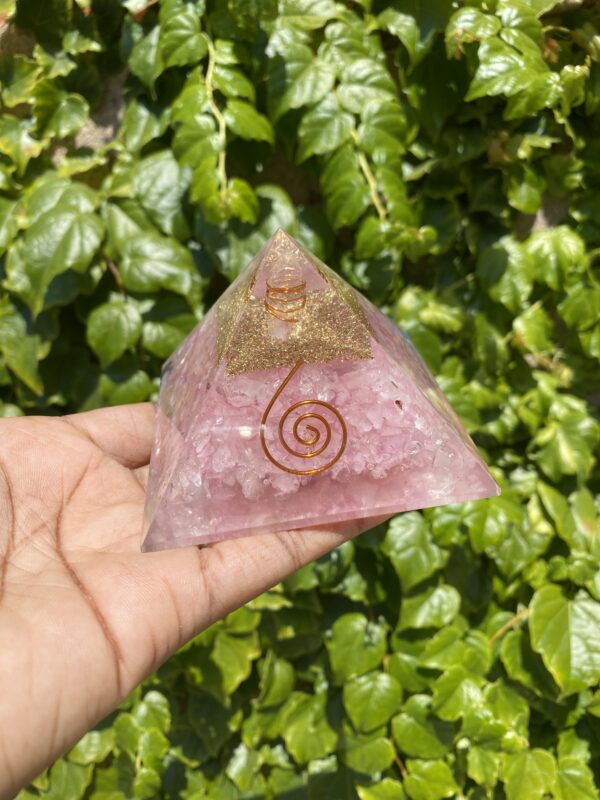 Pink crystal pyramid with gold and wire.