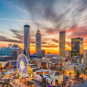 Atlanta skyline at sunset with Ferris wheel.