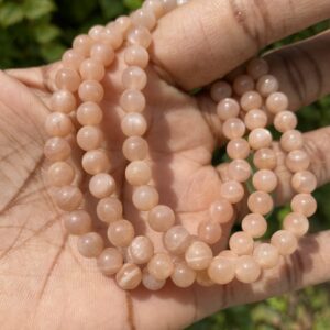 Sunstone bead bracelet on hand.