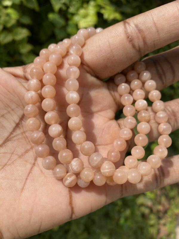 Sunstone bead bracelet on hand.