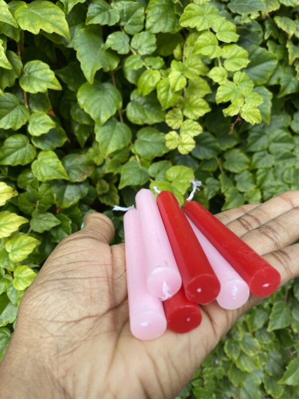 Red and pink candles in a hand.