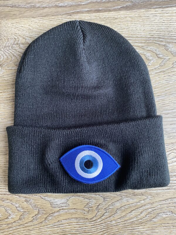 Black knit beanie with evil eye patch.