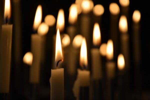 Lit candles in a dark room.