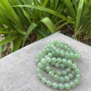 A stack of green beads sitting on top of a table.