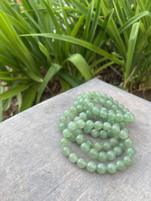 A stack of green beads sitting on top of a table.