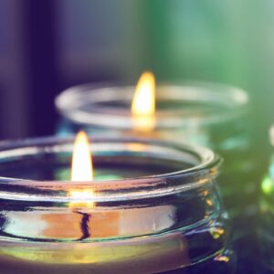 Close-up of candles in glass jars.