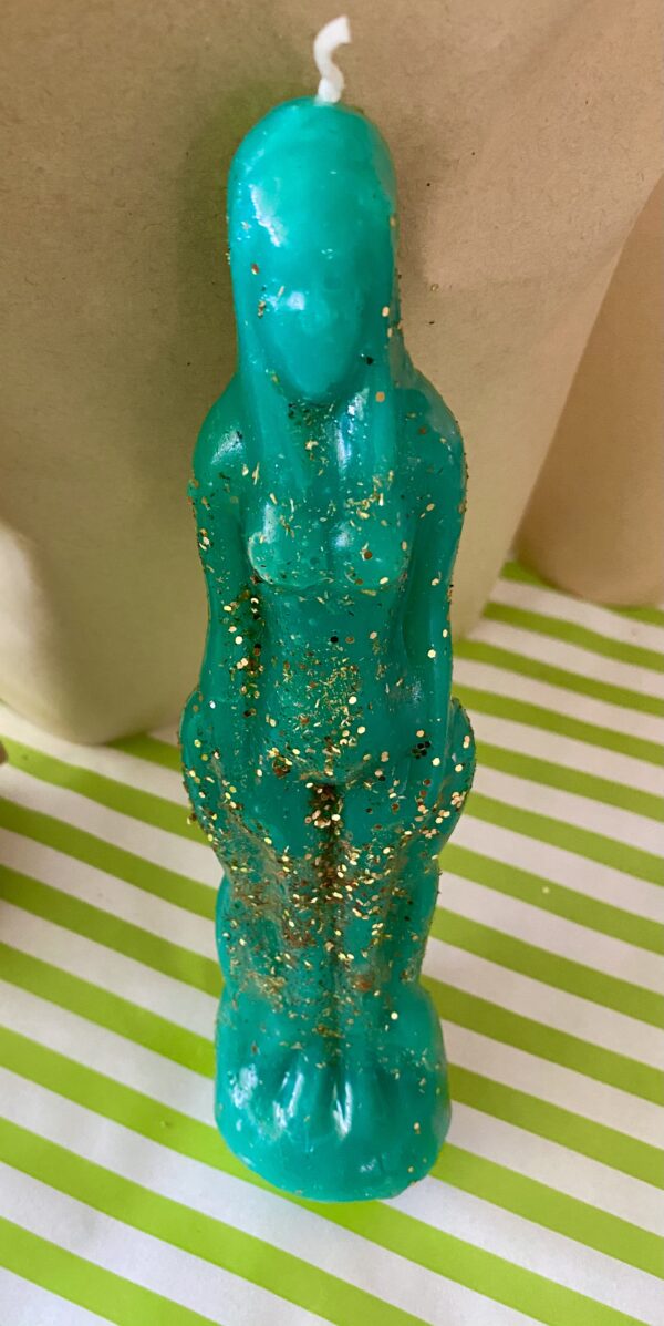 Teal glitter candle shaped like a woman.