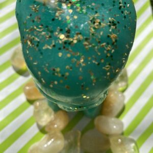 A green glass with gold speckles on it