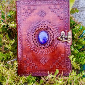 Brown leather journal with blue gem