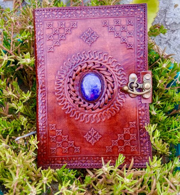 Brown leather journal with blue gem