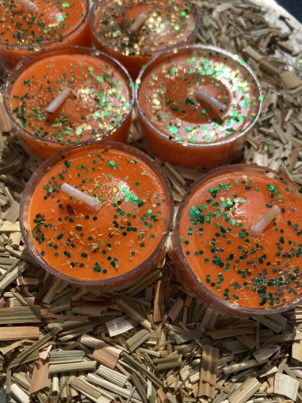 Orange scented candles with glitter.