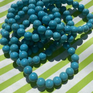 A close up of a string of beads on top of a table