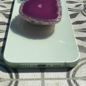 A phone with a purple heart on top of it.