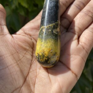 A person holding a stone in their hand.