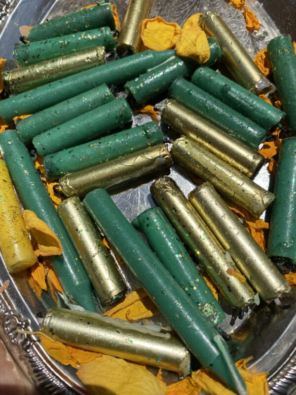 A bunch of green and yellow bullets are in the bin