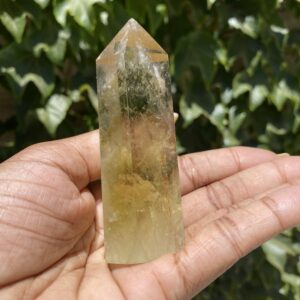 A person holding up an extra large crystal