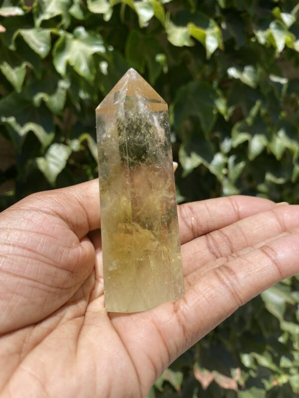 A person holding up an extra large crystal