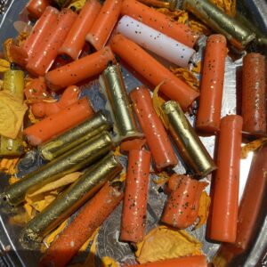 A close up of carrots and other vegetables in a pan.