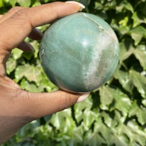 A person holding an apple in their hand.