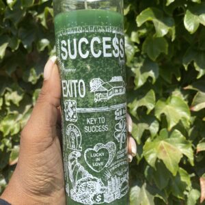 A person holding onto a candle with the word success written on it