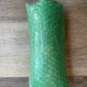 A green bubble wrap roll on top of a wooden table.