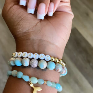 A hand with french manicure and a bracelet