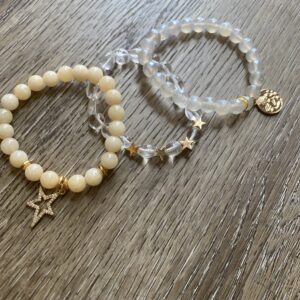 A pair of bracelets with a star and a bead.