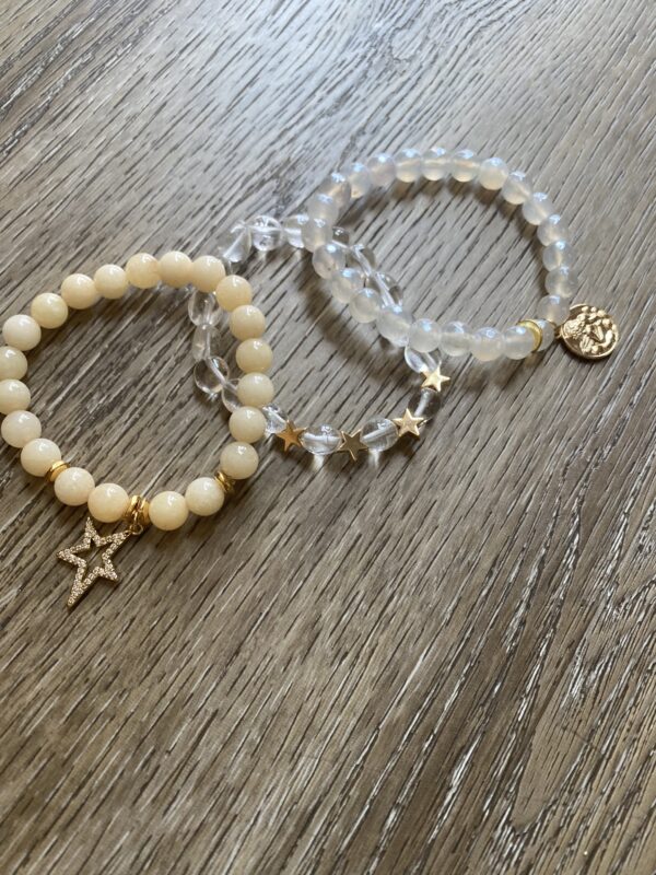 A pair of bracelets with a star and a bead.