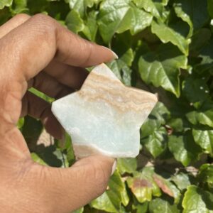 A person holding a piece of glass in their hand.