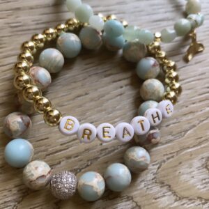 A bracelet with the word " breathe " on it.