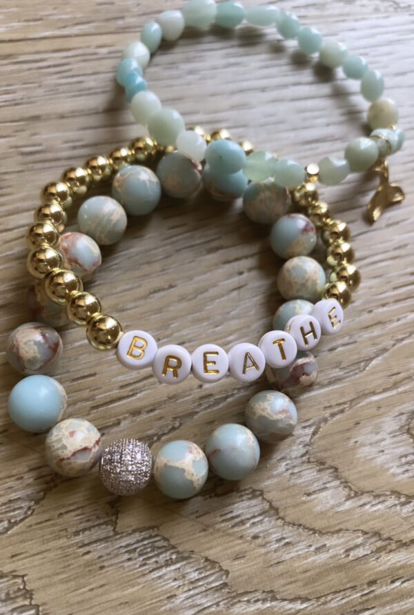 A bracelet with the word " breathe " on it.