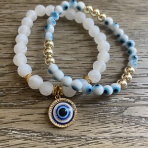 A pair of bracelets with an evil eye charm.