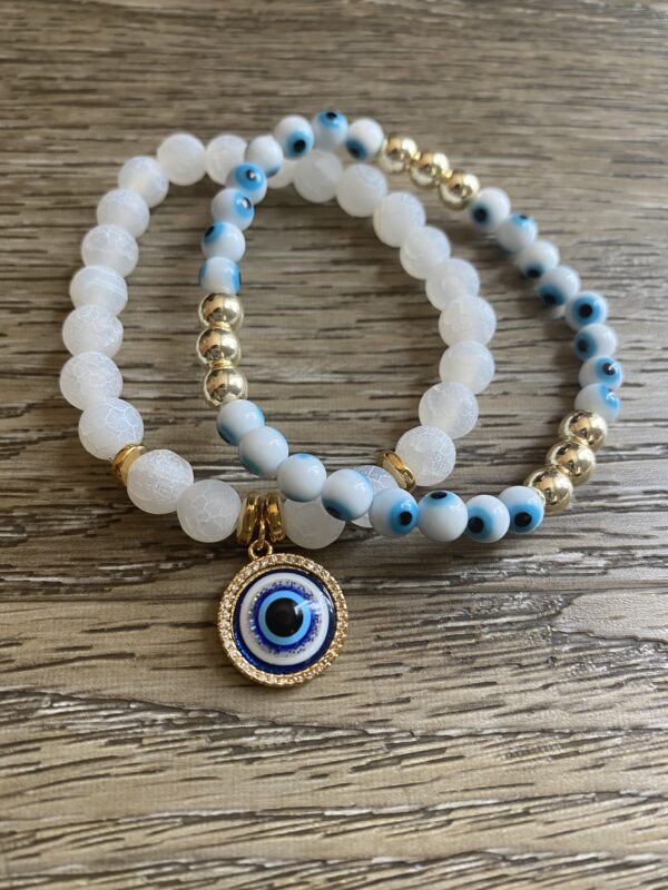 A pair of bracelets with an evil eye charm.