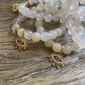 A close up of bracelets on top of a wooden table.