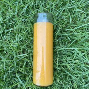 A yellow bottle sitting in the grass.