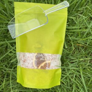 A bag of rice sitting on top of grass.