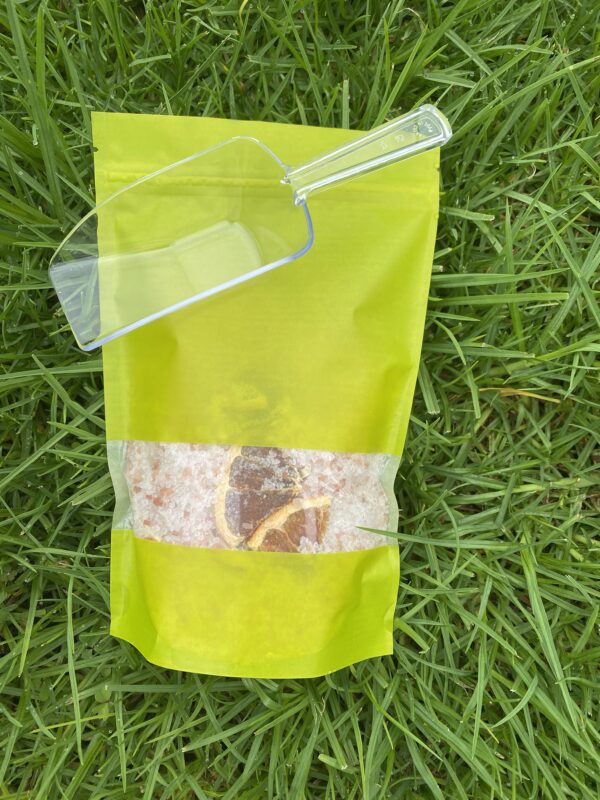 A bag of rice sitting on top of grass.